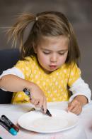 Sequoia decorates her china plate in an NGV Kids Tot Spot session. Tot Spot offers preschoolers quality time with their parents or carers as they explore the Gallery and take part in an art activity.
&copy; National Gallery of Victoria, Melbourne
