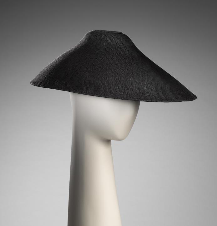 Yohji Yamamoto, Tokyo (fashion house)<br/>
est. 1972<br />
Yohji Yamamoto (designer)<br />
born Japan 1943<br />
<em>Hat</em> 2004 spring-summer, Jere collection<br />
straw<br />
123.5 cm (outer circumference) 11.5 cm (height) 41.0 cm (width)<br />
National Gallery of Victoria, Melbourne<br />
Gift from the Estate of Lady Grounds, 2009 (2009.171)<br />
© Yohji Yamamoto<br />