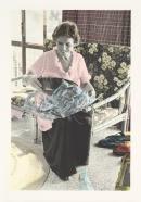 No title (Woman unwrapping Christmas presents)