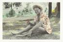 No title (Man wearing sun hat having a drink in park)