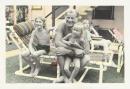 No title (Man and three children on garden chairs)