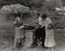No title (Woman with a teapot talking to man and woman)