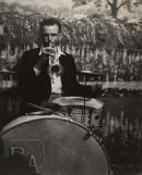 Members of the bush band that entertains hop pickers at dance are versatile. Here trumpet player doubles on drums.