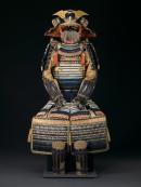 A suit of armour with horse saddle, stirrups and trappings