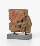 A monkey eating fruit, relief tile