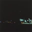 Night with two aircraft on flightline, military installation, Gulf