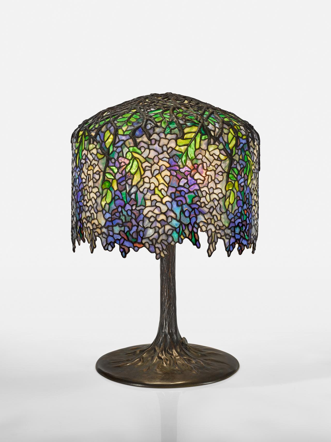 TIFFANY STUDIOS, Corona, New York (parent company)<br />
 TIFFANY FURNACES, Corona, New York (manufacturer)<br />
 Clara DRISCOLL (designer)<br/>
<em>Wisteria, table lamp</em> (1903-1905) <!-- (front) --><br />

glass, lead, bronze (patinated), electrical components<br />
68.6 x 47.0 cm diameter<br />
National Gallery of Victoria, Melbourne<br />
Purchased, NGV Women's Association, 2018<br />
2018.649<br />

<!--134705-->