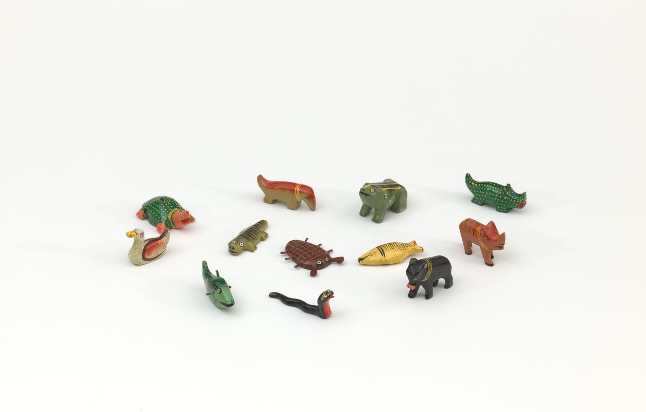 INDIAN<br/>
<em>Sea creatures</em> (c. 1970) <!-- (front) --><br />

coloured pigments on wood<br />
(a) 2.0 x 3.7 x 5.8 cm (turtle) (b) 2.2 x 1.4 x 5.4 cm (dugong) (c) 3.4 x 2.4 x 4.8 cm (frog) (d) 2.3 x 1.6 x 5.8 cm (crocodile) (e) 3.1 x 1.0 x 4.2 cm (bird) (f) 0.9 x 2.4 x 5.6 cm (young crocodile) (g) 0.7 x 4.1 x 5.0 cm (crustacean) (h) 2.1 x 1.2 x 5.4 cm (yellow and orange fish) (i) 3.4 x 1.5 x 4.6 cm (brown animal with black stripes) (j) 2.5 x 2.2 x 5.6 cm (green fish) (k) 3.3 x 1.5 x 4.5 cm (black animal) (l) 2.4 x 1.5 x 6.1 cm (snake)<br />
National Gallery of Victoria, Melbourne<br />
Gift of Alexandra and Leigh Copeland, 2021<br />
2021.476.a-l<br />

<!--146242-->