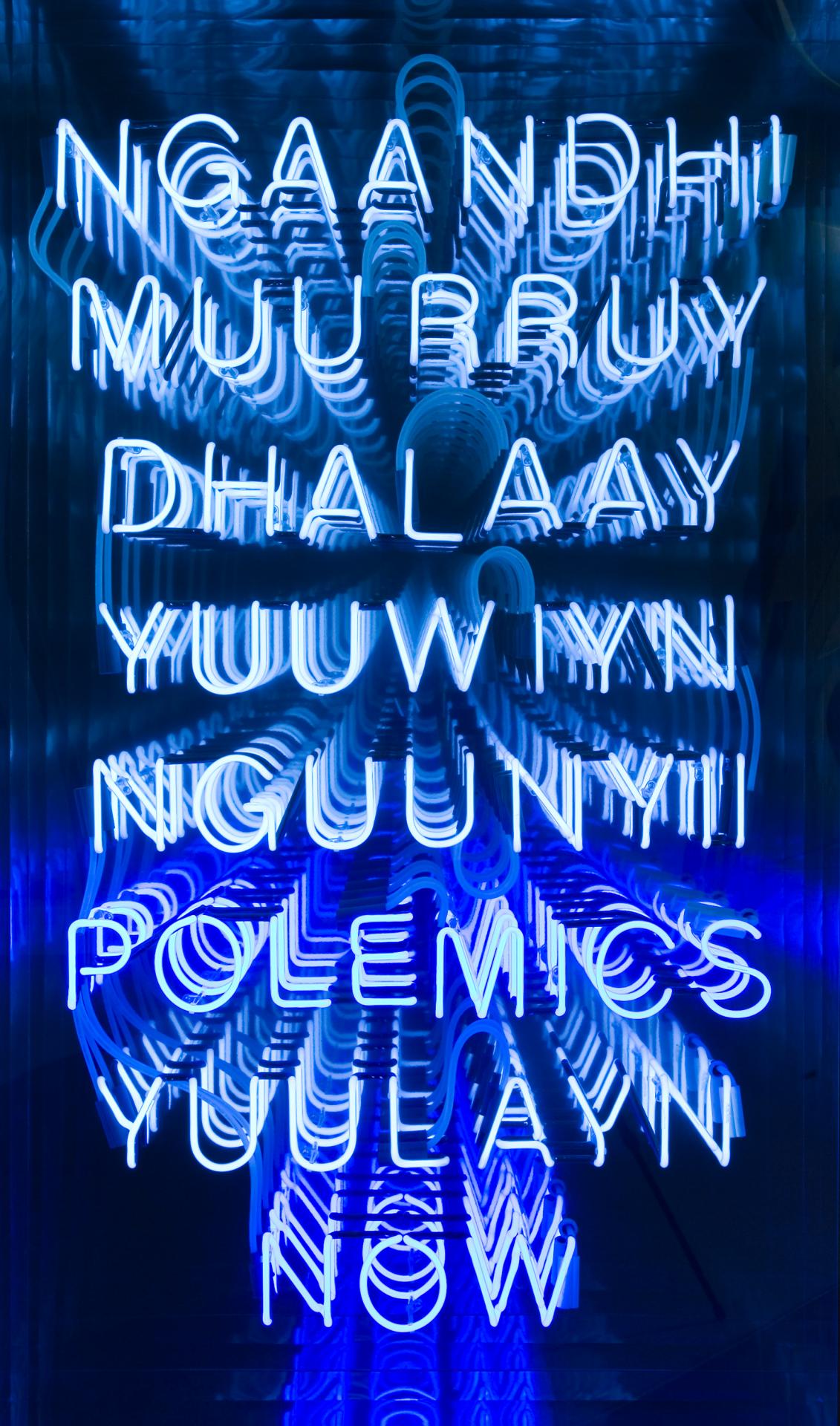 Brook ANDREW<br/>
<em>Polemics</em> (2000) <!-- (recto) --><br />

neon, mirror, transparent synthetic polymer resin<br />
172.5 x 102.3 cm<br />
National Gallery of Victoria, Melbourne<br />
Gift of the artist, 2002<br />
2002.39<br />
© Brook Andrew/Copyright Agency, 2023
<!--68466-->