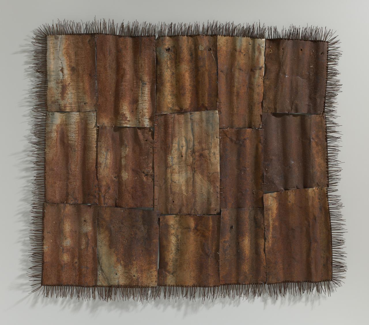 Lorraine Connelly-Northey<br/>
<em>Possum skin cloak</em> 2005-2006 (part)<br />
from <i>Hunter-gatherer</i> 2005-06<br />
rusted corrugated iron, wire<br />
119.5 x 131.5 x 5.0 cm<br />
National Gallery of Victoria, Melbourne<br />
Purchased, NGV Supporters and Patrons of Indigenous Art, 2006<br />
2006.336.1<br />
© Lorraine Connelly-Northey
<!--79306-->