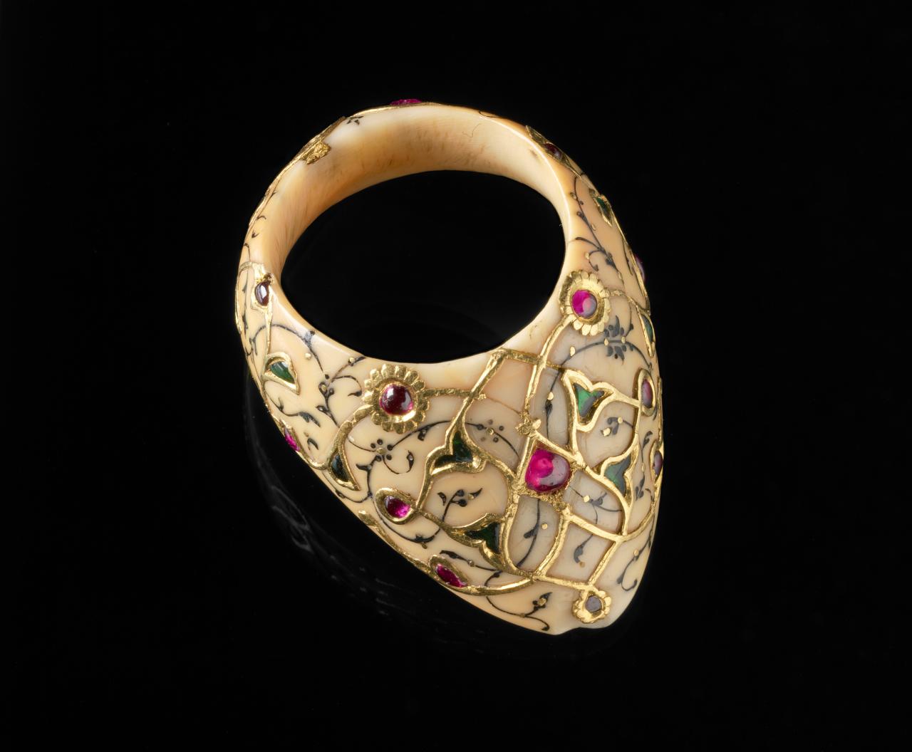 OTTOMAN TURKISH<br/>
<em>Archer's ring</em> (c. 1550) <!-- (full view) --><br />

ivory, gold, ruby, emerald<br />
3.9 x 3.1 x 1.8 cm<br />
National Gallery of Victoria, Melbourne<br />
Gift of Mr M. Stebbings, 1976<br />
AS107-1976<br />

<!--53229-->