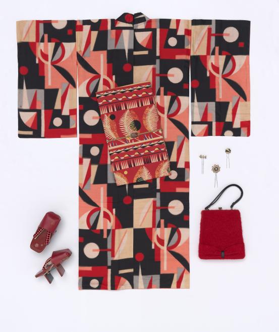 JAPANESE<br/>
<em>Women’s kimono with geometric design and accessories</em> c. 1930 <!-- (group view) --><br />

silk, cotton, wool, straw, wood, vinyl, plastic and metal (meisen textile)<br />
(a) 145.0 cm (centre back), 130.0 cm (cuff to cuff) (kimono) (b) 10.7 x 4.2 cm, 13.0 x 5.0 cm, 11.0 x 3.0 cm (hair pins) (c) 3.7 x 4.0 cm (sash brooch) (d) 42.5 x 25.0 cm (handbag) (e) 13.0 x 23.0 x 9.5 cm (sandals) (each) (f) 359.0 x 30.0 cm (sash) (obi)<br />
National Gallery of Victoria, Melbourne<br />
Purchased with funds donated by Allan Myers AC and Maria Myers AC, 2016<br />
2016.108<br />

<!--119788--><br/><a class="col-link block" href="/explore/collection/work/119788"><strong>Collection page <i class="fa fa-angle-right"></i></strong></a>