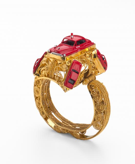 Robert BAINES<br/>
<em>Bracelet with fire car</em> (2001) <!-- (view 1) --><br />

silver-gilt, plastic, metal<br />
10.3 x 9.0 x 7.0 cm<br />
National Gallery of Victoria, Melbourne<br />
Purchased with funds from the Victorian Foundation for Living Australian Artists, 2005<br />
2005.496<br />
&copy; Robert Baines
<!--78419-->
