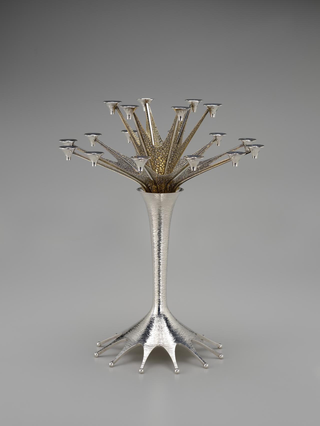 Stuart DEVLIN<br/>
<em>Eighteen-light candelabra</em> 1975 <!-- (full view) --><br />

sterling silver, silver-gilt<br />
56.0 x 45.7 x 45.8 cm<br />
National Gallery of Victoria, Melbourne<br />
Gift of Krystyna Campbell-Pretty AM and Family through the Australian Government's Cultural Gifts Program, 2024<br />
2024.8<br />
© Carole Devlin
<!--153477-->