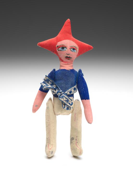 Mirka MORA<br/>
<em>Untitled (jester figure with articulated limbs)</em> (1970-1980) <!-- (front view ) --><br />

synthetic polymer paint on cotton<br />
(a) 22.5 x 11.0 x 2.0 cm (doll) (b) 1.0 x 5.0 cm (tied) (sash)<br />
National Gallery of Victoria, Melbourne<br />
Gift from the Estate of Mirka Mora, 2025<br />
2025.717<br />

<!--157388-->