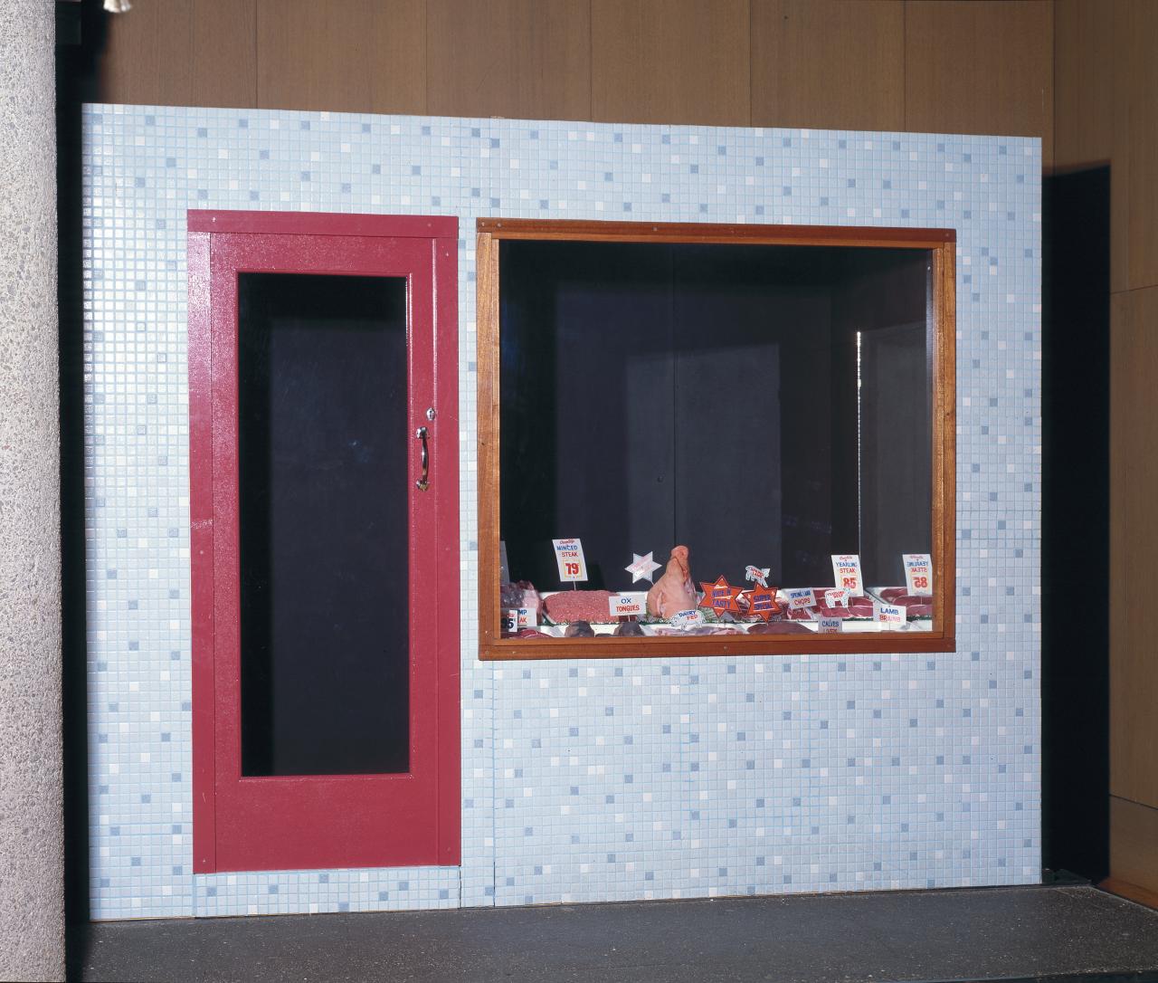 Ivan DURRANT<br/>
<em>Butcher shop</em> (1977-1978) <!-- (front) --><br />

synthetic polymer and enamel paint on composition board and wood, ceramic tiles, transparent synthetic polymer resin, mirror, steel, fluorescent light, plastic, polyvinyl chloride, metal, string<br />
(a-l) (241.0 x 303.0 x 128.7 cm) (overall)<br />
National Gallery of Victoria, Melbourne<br />
Gift of Mr and Mrs Burdett A. Laycock, 1978<br />
A15.a-l-1978<br />
© Ivan Durrant
<!--3388-->