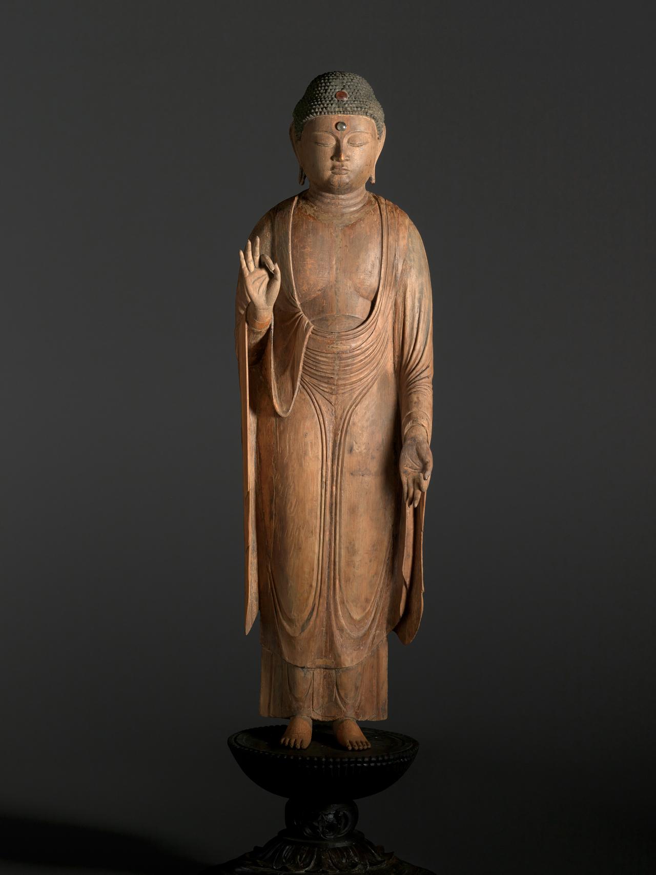 <em>Amida Buddha (Amida Nyorai)</em><br/>
Heian period (12th century) Japan<br/>
lacquer, gold and pigment on Cypress (<em>Hinoki</em>), crystals<br/>
118.5 x 36.1 cm (overall)<br/>
National Gallery of Victoria, Melbourne<br/>
Purchased with funds donated by Allan Myers AO and Maria Myers AO, 2010 (2010.3)<br/>