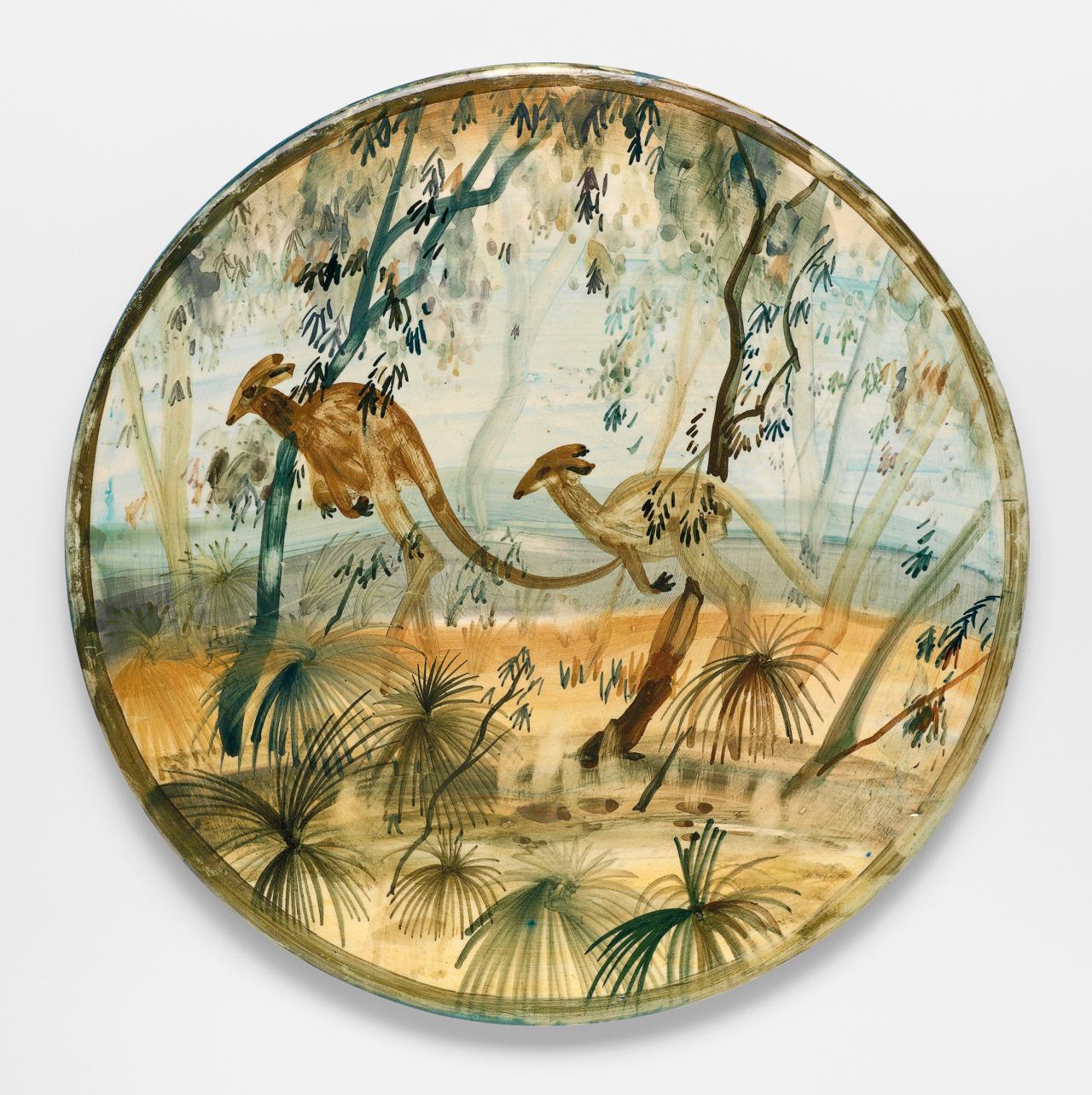 Neil Douglas <br/>
Australian 1911–2003, emigrated to Australia 1912<br/>
<em>Kangaroo platter</em> c.1950<br/>
earthenware<br/>
31.5 cm diameter<br/>
National Gallery of Victoria, Melbourne<br/>
Kenneth Hood Bequest Fund, 2012 (2012.24)<br/>