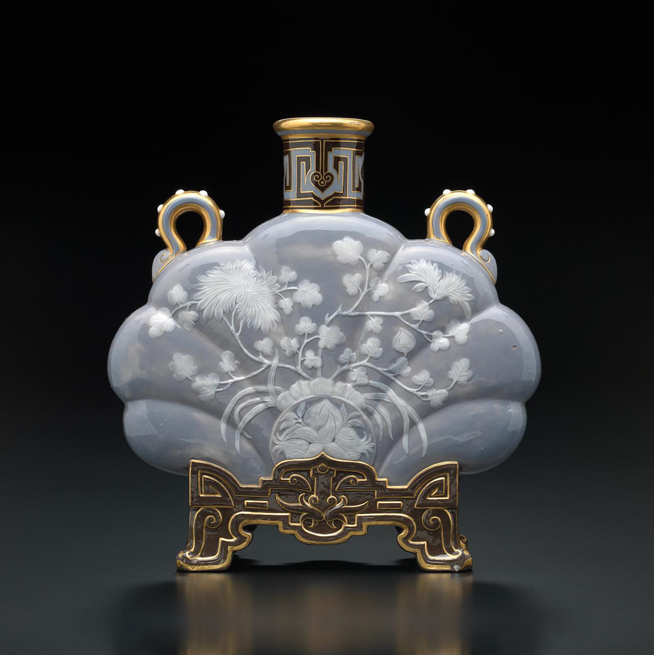 Minton, Stoke-on-Trent, Staffordshire (manufacturer)<br/>
England est. 1793<br/>
Charles Toft (Senior) (designer and decorator) (attributed to)<br/>
England c.1828-90<br/>
<em>Vase</em> c.1875<br/>
porcelain (<em>pâte-sur-pâte</em>)<br/>
23.7 x 23.1 x 7.4 cm<br/>
National Gallery of Victoria, Melbourne<br/>
The Dr Robert Wilson Collection. Gift of Dr Robert Wilson and Colin Lane through the Australian Government’s Cultural Gifts Program, 2012 (2012.429)<br/>