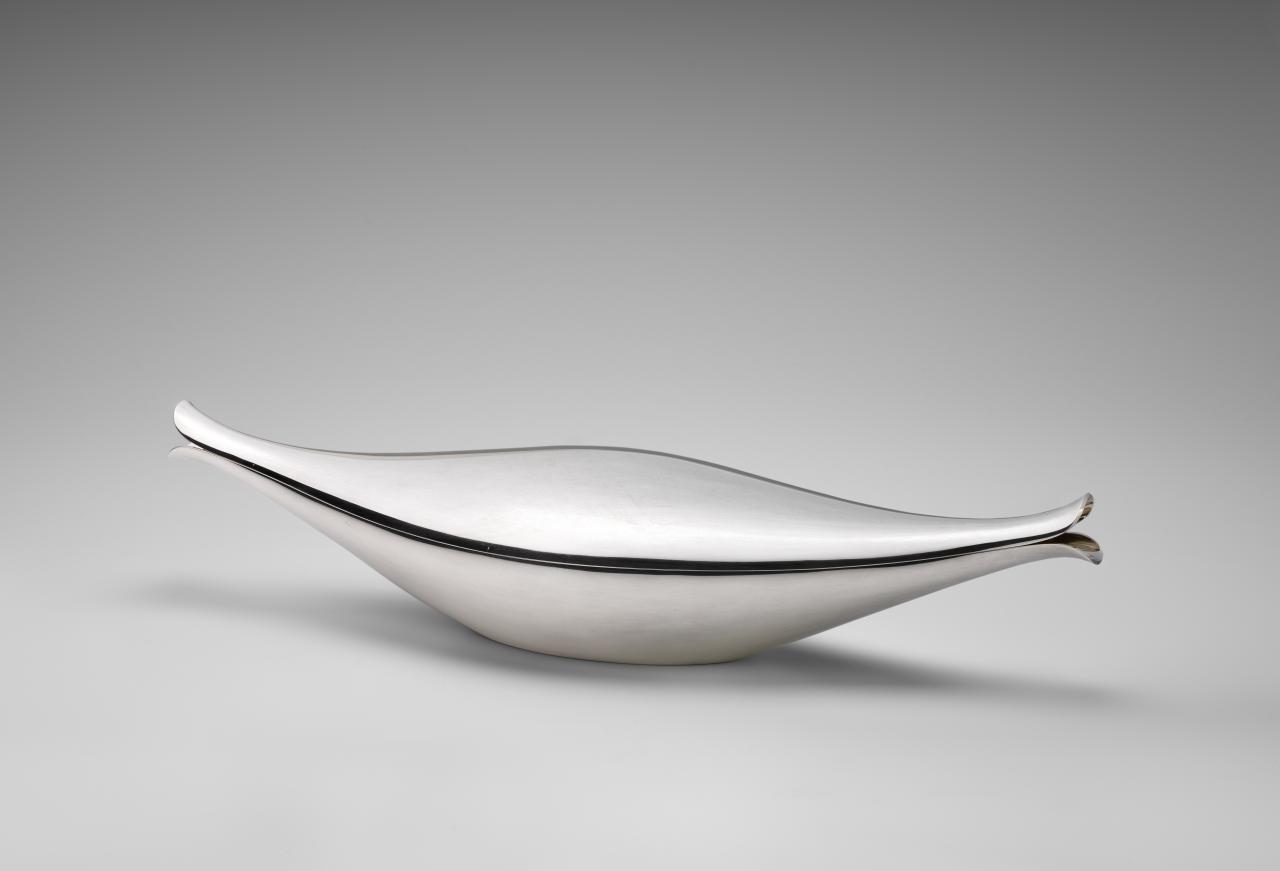 GEORG JENSEN SØLVSMEDIE, Copenhagen (manufacturer)<br/>
Denmark est. 1904<br/>
Henning KOPPEL (designer)<br/>
Denmark 1918–81<br/>
<em>Fish dish, model no. 853</em> (1956) designed, (c. 1980) manufactured<br/>
silver<br/>
(a-b) 14.2 x 71.2 x 19.2 cm (overall)<br/>
National Gallery of Victoria, Melbourne<br/>
Purchased with the assistance of Georg Jensen Silversmiths Ltd to mark the centenary of Georges Australia Ltd, 1980 (D433.a-b-1980)<br/>