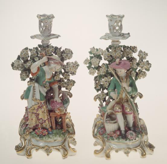 CHELSEA PORCELAIN FACTORY, London (manufacturer)<br/>
<em>Rustic pursuits, candlesticks</em> (c. 1765) <!-- (group) --><br />

porcelain (soft-paste)<br />
(1) 31.2 x 16.3 x 13.1 cm (lady killing a chichen) (2) 31.2 x 16.6 x 13.2 cm (gentleman fishing)<br />
National Gallery of Victoria, Melbourne<br />
The Colin Templeton Collection. Gift of Mrs Colin Templeton, 1942<br />
395.1-2-D4<br />

<!--73955-->