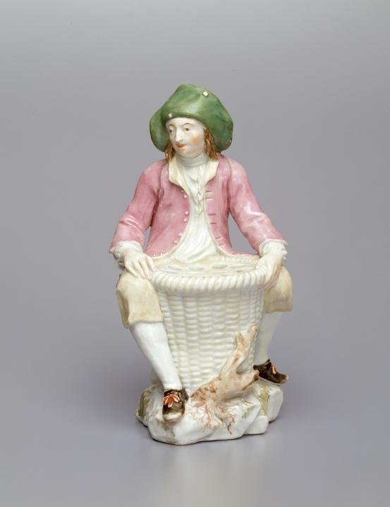 CHELSEA PORCELAIN FACTORY, London (manufacturer)<br/>
<em>Fisherman, flower holder</em> (c. 1755) <!-- (full view) --><br />

porcelain (soft-paste)<br />
21.9 x 11.7 x 11.7 cm<br />
National Gallery of Victoria, Melbourne<br />
Felton Bequest, 1939<br />
4473-D3<br />

<!--17533-->