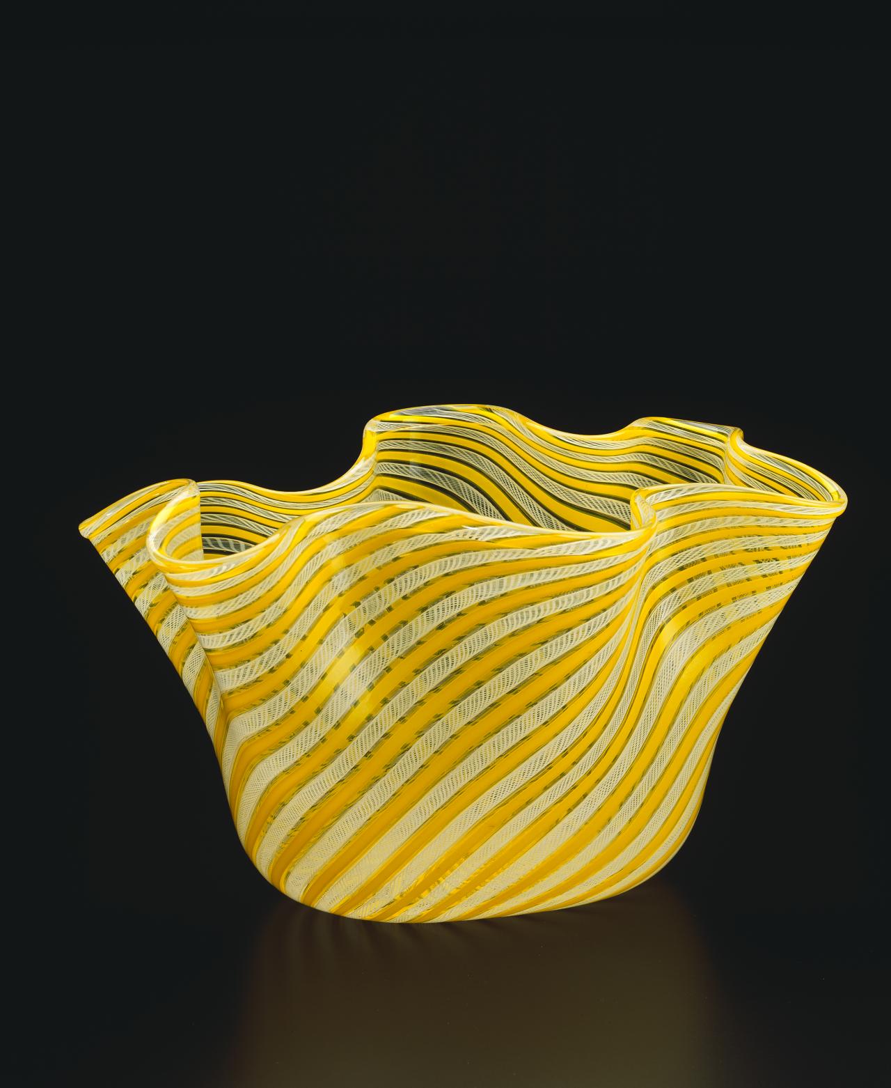 VENINI & CO., Murano (manufacturer)<br />
 Fulvio BIANCONI (designer)<br/>
<em>Handkerchief (Fazzoletto) vase</em> 1949 {designed}; (c. 1950-1960) {manufactured} <!-- (full view) --><br />

glass (vetro a retorti decoration)<br />
19.8 x 34.0 x 21.7 cm<br />
National Gallery of Victoria, Melbourne<br />
Purchased from Admission Funds, 1989<br />
D29-1989<br />
© Fulvio Bianconi/SIAE, Rome. Licensed by Copyright Agency, Australia
<!--21093-->