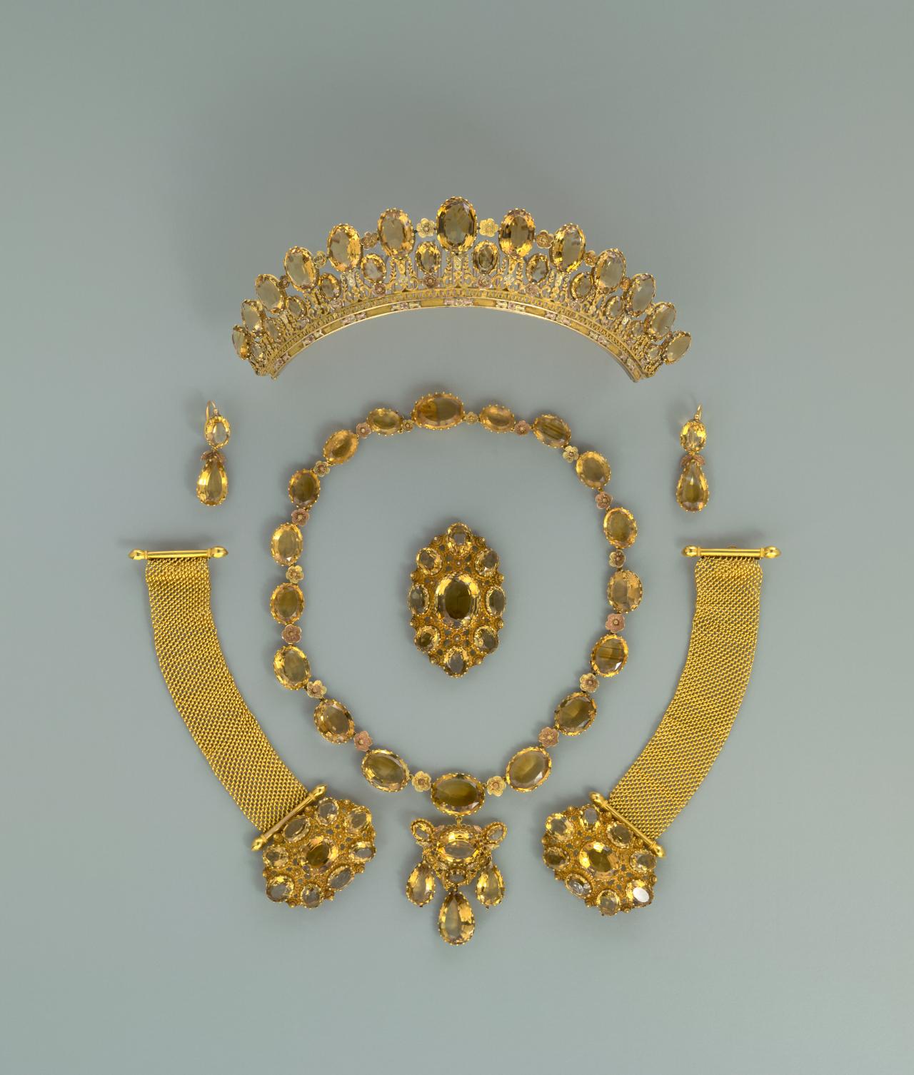 FRANCE, (Paris)<br/>
<em>Parure</em> (c. 1826) <!-- (view 1) --><br />

gold, citrine<br />
(a) 7.5 x 17.5 x 7.9 cm (diadem) (b-c) 24.5 x 12.0 x 1.2 cm (necklace and pendant) (d) 5.5 x 5.0 x 5.3 cm (bracelet) (e) 5.5 x 5.0 x 5.3 cm (bracelet) (f) 6.0 x 3.8 x 1.5 cm (belt slide) (g) 4.1 x 1.3 x 1.2 cm (earring) (h) 4.2 x 1.3 x 1.4 cm (earring) (i) 4.3 x 2.5 x 0.5 cm (fitting) (j) 4.3 x 2.7 x 0.5 cm (fitting)<br />
National Gallery of Victoria, Melbourne<br />
Purchased, 1980<br />
D384.a-j-1980<br />

<!--15926-->