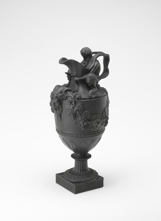 WEDGWOOD, Staffordshire, Stoke-on-Trent (manufacturer)<br />
 John FLAXMAN (designer)<br/>
<em>Sacred to Bacchus, ewer</em> (c. 1860-1870) <!-- (recto) --><br />

stoneware (black basalt)<br />
43.6 x 22.0 x 17.4 cm<br />
National Gallery of Victoria, Melbourne<br />
Felton Bequest, 1915<br />
1782-D3<br />

<!--17169--><br/><a class="col-link block" href="/explore/collection/work/17169"><strong>Collection page <i class="fa fa-angle-right"></i></strong></a>