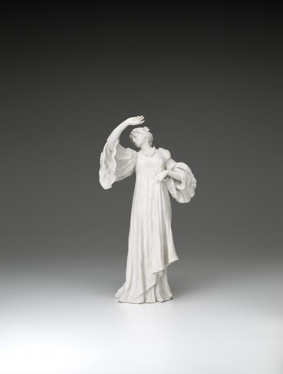 S&Egrave;VRES PORCELAIN FACTORY, S&egrave;vres (manufacturer)<br />
 Agathon L&Eacute;ONARD (modeller)<br/>
<em>Dancer with marguerite daisy, from The Scarf Dance table centrepiece, model no. 7</em> 1898 {modelled}; (1900-1923) {manufactured} <!-- (front) --><br />
<em>(Danseuse &agrave; la marguerite, from the table centrepeice Le Jeu de L&rsquo;&Eacute;charpe)</em><br />
porcelain (biscuit, hard paste)<br />
45.0 x 23.4 x 18.3 cm<br />
National Gallery of Victoria, Melbourne<br />
Gift of Krystyna Campbell-Pretty AM and Family through the Australian Government's Cultural Gifts Program, 2021<br />
2021.539<br />

<!--146189-->