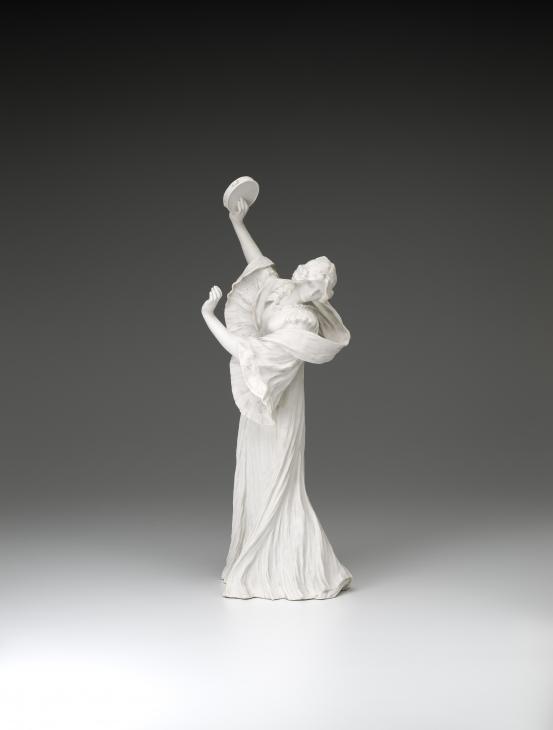 S&Egrave;VRES PORCELAIN FACTORY, S&egrave;vres (manufacturer)<br />
 Agathon L&Eacute;ONARD (modeller)<br/>
<em>Dancer with tambourine (right), from The Scarf Dance table centrepiece, model no. 4</em> 1898 {modelled}; (1909) {manufactured} <!-- (front) --><br />
<em>(Danseuse au tambourin, from the table centrepiece Le Jeu de L&rsquo;&Eacute;charpe)</em><br />
porcelain (biscuit, hard paste)<br />
51.9 x 25.0 x 17.4 cm<br />
National Gallery of Victoria, Melbourne<br />
Gift of Krystyna Campbell-Pretty AM and Family through the Australian Government's Cultural Gifts Program, 2021<br />
2021.536<br />

<!--146185-->