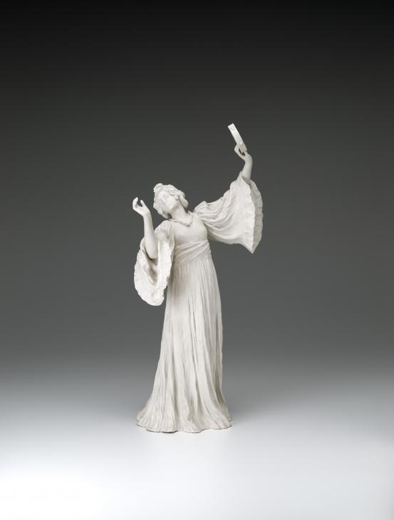 S&Egrave;VRES PORCELAIN FACTORY, S&egrave;vres (manufacturer)<br />
 Agathon L&Eacute;ONARD (modeller)<br/>
<em>Dancer with tambourine (left), from The Scarf Dance table centrepiece, model no. 6</em> 1898 {modelled}; (1909) {manufactured} <!-- (front) --><br />
<em>(Danseuse au tambourin, from the table centrepiece Le Jeu de L&rsquo;&Eacute;charpe)</em><br />
porcelain (biscuit, hard paste)<br />
51.9 x 25.0 x 17.4 cm<br />
National Gallery of Victoria, Melbourne<br />
Gift of Krystyna Campbell-Pretty AM and Family through the Australian Government's Cultural Gifts Program, 2021<br />
2021.538<br />

<!--146186-->