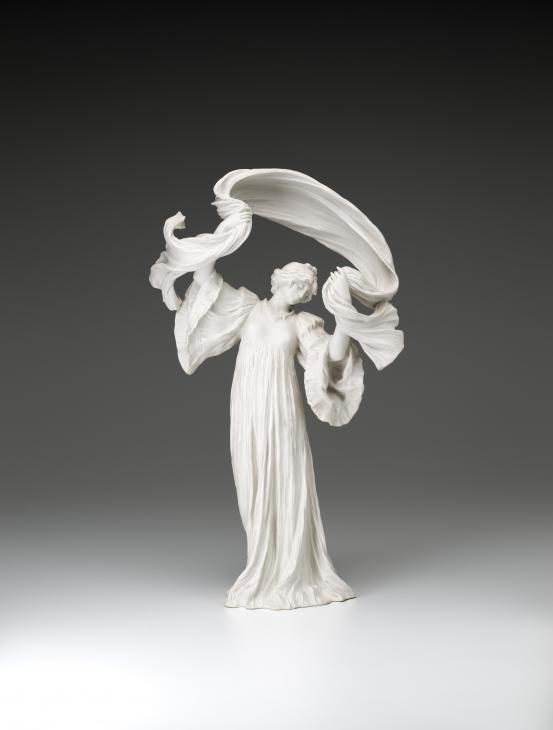 S&Egrave;VRES PORCELAIN FACTORY, S&egrave;vres (manufacturer)<br />
 Agathon L&Eacute;ONARD (modeller)<br/>
<em>Dancer with scarf her right foot raised, from The Scarf Dance table centrepiece, model no. 11</em> 1898 {modelled}; (1923) {manufactured} <!-- (front) --><br />
<em>(Danseuse &agrave; l&rsquo;&eacute;charpe pied droit lev&eacute;, from the table centrepiece Le Jeu de L&rsquo;&Eacute;charpe)</em><br />
porcelain (biscuit, hard paste)<br />
51.8 x 31.2 x 16.4 cm<br />
National Gallery of Victoria, Melbourne<br />
Gift of Krystyna Campbell-Pretty AM and Family through the Australian Government's Cultural Gifts Program, 2021<br />
2021.541<br />

<!--146180-->