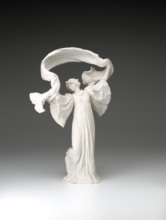 S&Egrave;VRES PORCELAIN FACTORY, S&egrave;vres (manufacturer)<br />
 Agathon L&Eacute;ONARD (modeller)<br/>
<em>Dancer with scarf her knee raised, from The Scarf Dance table centrepiece, model no. 12</em> 1898 {modelled}; (1923) {manufactured} <!-- (front) --><br />
<em>(Danseuse &agrave; l&rsquo;&eacute;charpe genou lev&eacute;, from the table centrepiece Le Jeu de L&rsquo;&Eacute;charpe)</em><br />
porcelain (biscuit, hard paste)<br />
53.0 x 35.0 x 16.7 cm<br />
National Gallery of Victoria, Melbourne<br />
Gift of Krystyna Campbell-Pretty AM and Family through the Australian Government's Cultural Gifts Program, 2021<br />
2021.542<br />

<!--146182-->