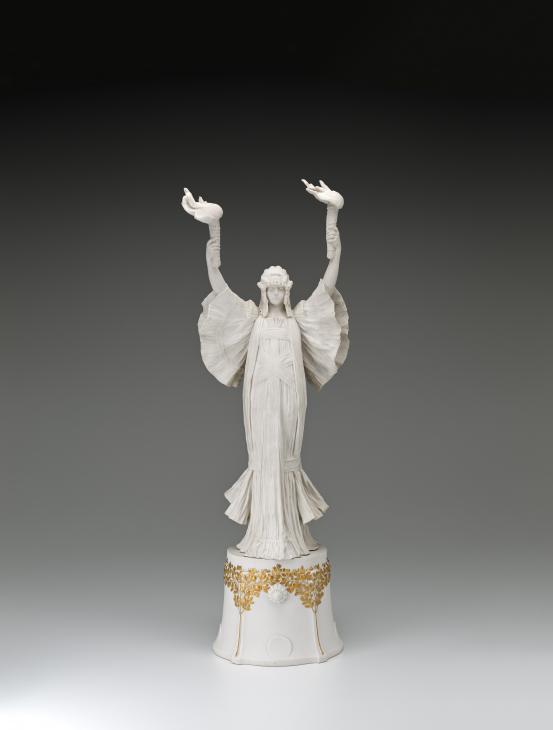 S&Egrave;VRES PORCELAIN FACTORY, S&egrave;vres (manufacturer)<br />
 Agathon L&Eacute;ONARD (modeller)<br/>
<em>Dancer with torches (right) on pedestal, from The Scarf Dance table centrepiece, model no. 15</em> 1898 {modelled}; (1900) {manufactured} <!-- (front) --><br />
<em>(Danseuse aux flambeaux &agrave; gauche, from the table centrepiece Le Jeu de L&rsquo;&Eacute;charpe)</em><br />
porcelain (biscuit, hard paste)<br />
(a-b) 72.1 x 23.4 x 17.3 cm (overall)<br />
National Gallery of Victoria, Melbourne<br />
Gift of Krystyna Campbell-Pretty AM and Family through the Australian Government's Cultural Gifts Program, 2021<br />
2021.543.a-b<br />

<!--146183-->
