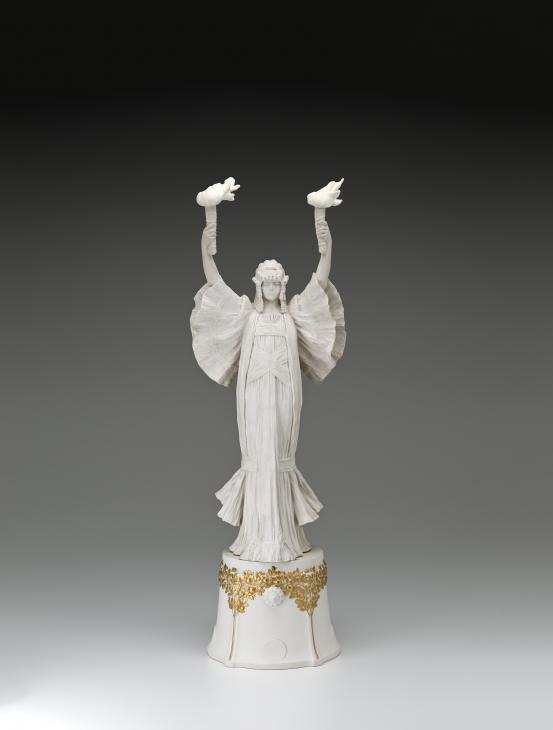 S&Egrave;VRES PORCELAIN FACTORY, S&egrave;vres (manufacturer)<br />
 Agathon L&Eacute;ONARD (modeller)<br/>
<em>Dancer with torches (left) on pedestal, from The Scarf Dance table centrepiece, model no. 1</em> 1898 {modelled}; (1923) {manufactured} <!-- (front) --><br />
<em>(Danseuse aux flambeaux &agrave; droite, from Le Jeu de L&rsquo;&Eacute;charpe table centrepiece)</em><br />
porcelain (biscuit, hard paste)<br />
(a-b) 71.5 x 23.6 x 19.8 cm (overall)<br />
National Gallery of Victoria, Melbourne<br />
Gift of Krystyna Campbell-Pretty AM and Family through the Australian Government's Cultural Gifts Program, 2021<br />
2021.533.a-b<br />

<!--146184-->