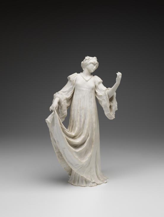 S&Egrave;VRES PORCELAIN FACTORY, S&egrave;vres (manufacturer)<br />
 Agathon L&Eacute;ONARD (modeller)<br/>
<em>Dancer lifting her dress, from The Scarf Dance table centrepiece, model no. 9</em> 1898 {designed}; 1900 {manufactured} <!-- (view 1) --><br />
<em>(Danseuse relevant sa jupe, from the table centrepiece Le Jeu de L&rsquo;&Eacute;charpe)</em><br />
porcelain (biscuit, hard paste)<br />
42.1 x 24.3 x 17.4 cm<br />
National Gallery of Victoria, Melbourne<br />
Gift of Krystyna Campbell-Pretty AM and Family through the Australian Government's Cultural Gifts Program, 2023<br />
2023.7<br />

<!--150369-->