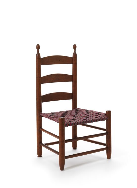 UNITED STATES, New York, New Lebanon<br/>
<em>Tilting chair</em> (c. 1840) <!-- (front 3/4) --><br />

Maple (Acer. sp.), cotton, (other materials)<br />
71.1 x 40.8 x 33.8 cm<br />
National Gallery of Victoria, Melbourne<br />
Gift of Peter and Eloise Smyrl, 2025<br />
2025.46<br />

<!--156327-->