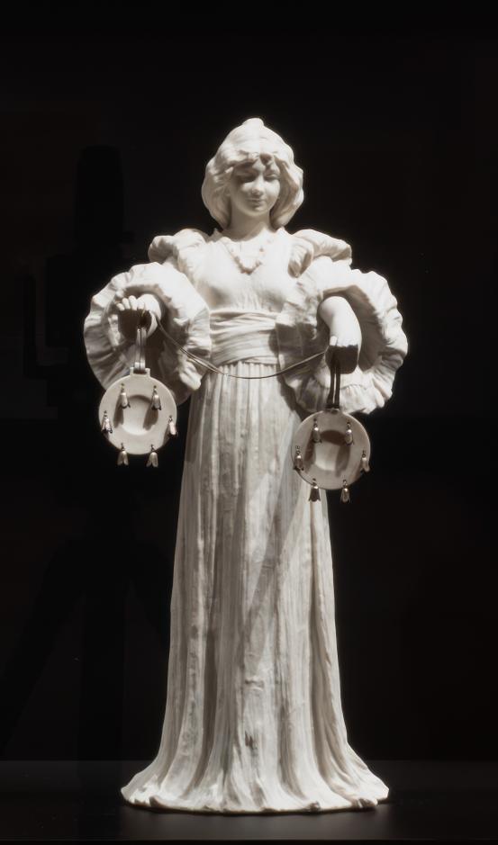 S&Egrave;VRES PORCELAIN FACTORY, S&egrave;vres (manufacturer)<br />
 Agathon L&Eacute;ONARD (modeller)<br/>
<em>Dancer with cymbals, from The Scarf Dance table centrepiece, model no. 10</em> (1898) {modelled}; (1900-1932) {manufactured} <!-- (installation) --><br />
<em>(Danseuse relevant sa jupe, du centre de table Le Jeu de L&rsquo;&Eacute;charpe)</em><br />
porcelain (biscuit, hard paste), silver<br />
(a-b) 42.0 x 19.5 x 24.1 cm (overall)<br />
National Gallery of Victoria, Melbourne<br />
Gift of Krystyna Campbell-Pretty AM and Family through the Australian Government's Cultural Gifts Program, 2025<br />
2025.660.a-b<br />

<!--157218-->