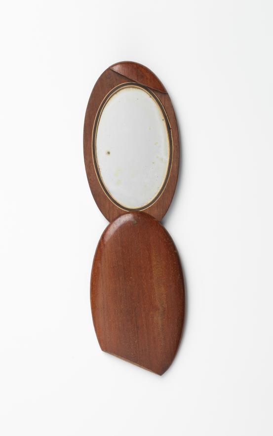 UNITED STATES, New England (manufacturer)<br/>
<em>Compact mirror</em> (late 19th century) <!-- (view 1) --><br />

wood, mirror, iron<br />
12.0 x 11.3 x 1.1 cm (partially open)<br />
National Gallery of Victoria, Melbourne<br />
Marjorie Josephs-Wilks Bequest, 2025<br />
<br />

<!--158414-->