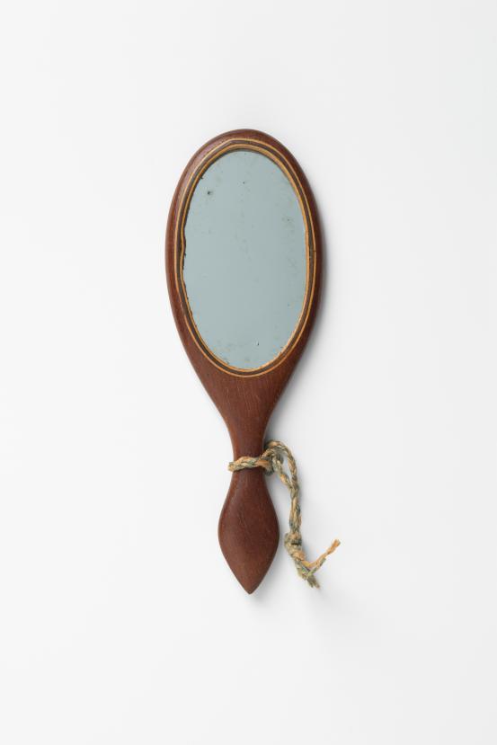 UNITED STATES, New England (manufacturer)<br/>
<em>Hand mirror</em> (late 19th century) <!-- (view 1) --><br />

wood, mirror<br />
11.7 x 4.0 x 0.4 cm<br />
National Gallery of Victoria, Melbourne<br />
Marjorie Josephs-Wilks Bequest, 2025<br />
<br />

<!--158428-->