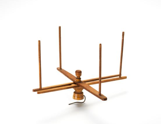 UNITED STATES, New England (manufacturer)<br/>
<em>Table swift</em> (c. 1900) <!-- (full view) --><br />

wood, string (cotton), metal<br />
(8.3 x 48.2 cm) diameter<br />
National Gallery of Victoria, Melbourne<br />
Marjorie Josephs-Wilks Bequest, 2025<br />
<br />

<!--158430-->