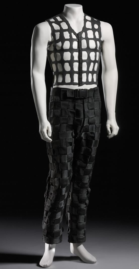 TRAGEDY DESIGN, Melbourne (fashion house)<br />
 Steven BRUTON (designer)<br/>
<em>Lacetex vest and trousers</em> 1995 <!-- (view 1) --><br />

latex, polypropylene, metal<br />
(a) 52.0 cm (centre back) 37.0 cm (width) (vest) (b) 103.0 cm (outer leg) 42.5 cm (waist, flat) (trousers)<br />
National Gallery of Victoria, Melbourne<br />
Purchased, 1994<br />
CT444.a-b-1994<br />

<!--55997--><br/><a class="col-link block" href="/explore/collection/work/55997"><strong>Collection page <i class="fa fa-angle-right"></i></strong></a>