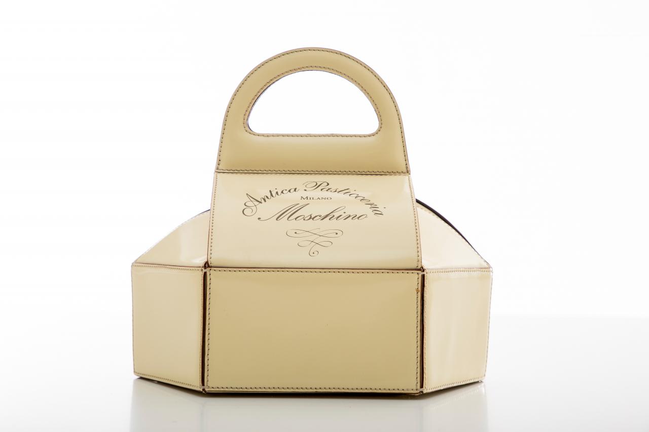 MOSCHINO, Italy (fashion house)<br />
 Franco MOSCHINO (designer)<br/>
<em>Antica Pasticceria Milano, handbag</em> (c. 1991) <!-- (front) --><br />

leather, acetate (lining) metal (fastenings)<br />
19.0 x 19.5 x 15.5 cm<br />
National Gallery of Victoria, Melbourne<br />
Purchased with funds donated by the Bertocchi family, 2020<br />
2020.707<br />

<!--144642-->