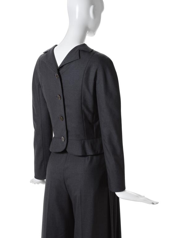 CHRISTIAN DIOR, Paris (couture house)<br />
 John GALLIANO (designer)<br/>
<em>Suit</em> 1999 {Surrealist collection, spring-summer 1999} (detail)<br />

wool, silk, metal (fastenings)<br />
(a) 37.0 cm (centre back) 58.0 cm (sleeve length) (jacket) (b) 110.0 cm (outer leg) 35.0 cm (waist flat) (trousers)<br />
National Gallery of Victoria, Melbourne<br />
Gift of Krystyna Campbell-Pretty AM and Family through the Australian Government&rsquo;s Cultural Gift Program, 2023<br />
2023.329.a-b<br />

<!--151083--><br/><a class="col-link block" href="/explore/collection/work/151083"><strong>Collection page <i class="fa fa-angle-right"></i></strong></a>