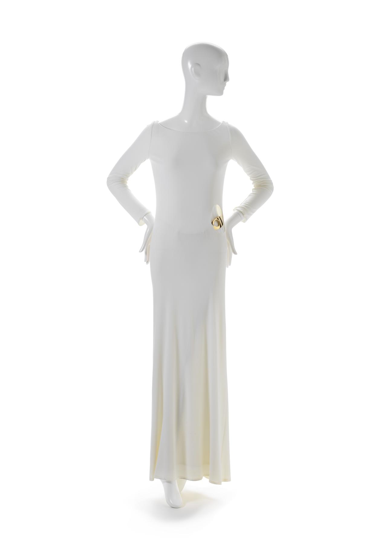 GUCCI, Florence (fashion house)<br />
 Tom FORD<br/>
<em>Dress</em> 1996 <!-- (front) --><br />

synthetic fabric (jersey), metal<br />
(a) 151.0 cm (centre back) 38.0 cm (waist, flat) (dress) (b) 22.0 x 36.5 x 3.0 cm (g-string)<br />
National Gallery of Victoria, Melbourne<br />
Purchased, NGV Supporters of Fashion and Textiles, 2018<br />
2018.259.a-b<br />

<!--133428-->