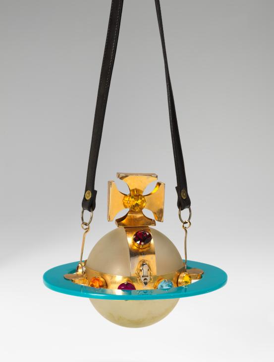 VIVIENNE WESTWOOD, London (fashion house)<br />
 Vivienne WESTWOOD (designer)<br/>
<em>Orb, handbag</em> (c. 1989) <!-- (full view) --><br />

plastic, metal, imitation jewels, opaque synthetic polymer resin, leather<br />
19.0 x 22.0 x 22.0 cm<br />
National Gallery of Victoria, Melbourne<br />
Purchased, 1996<br />
1996.714<br />

<!--59410--><br/><a class="col-link block" href="/explore/collection/work/59410"><strong>Collection page <i class="fa fa-angle-right"></i></strong></a>