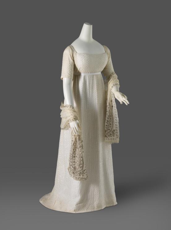 (ENGLAND)<br/>
<em>Evening gown</em> (c. 1805) <!-- (full view) --><br />

cotton (muslin), glass (beads), metal (thread)<br />
(a) 128.0 cm (centre back) 22.0 cm (sleeve length) (gown) (b) 44.0  x 214.0 cm (veil)<br />
National Gallery of Victoria, Melbourne<br />
Gift of Krystyna Campbell-Pretty AM and Family through the Australian Government&rsquo;s Cultural Gift Program, 2025<br />
2025.731.a-b<br />

<!--156855-->