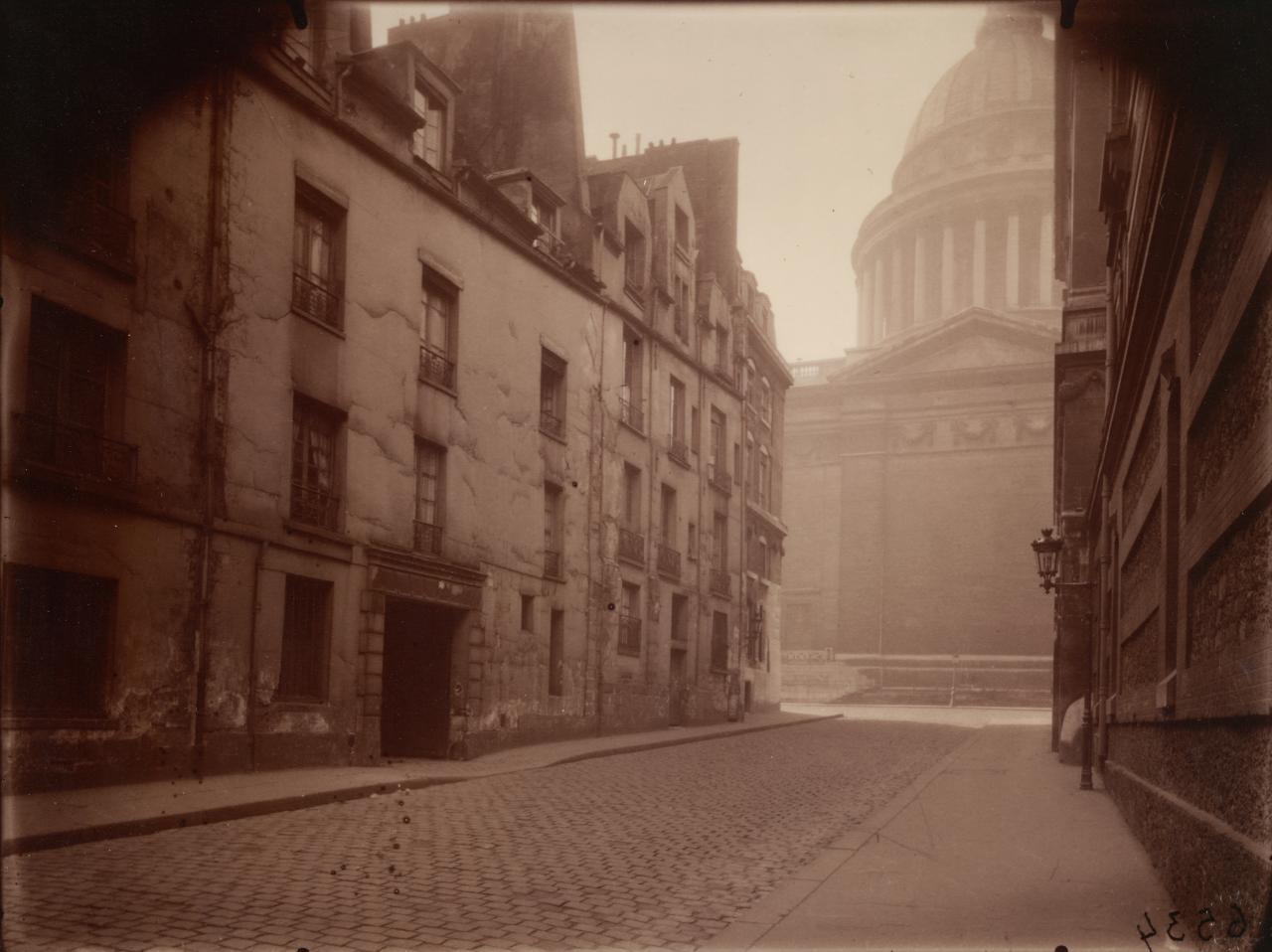 Eugène ATGET<br/>
<em>Corner of rue Valette and the Pantheon, 5th arrondissement, March morning</em> (1925); 1978 {printed} <!-- (recto) --><br />
<em>(Coin de la rue Valette et Pantheon, 5e arrondissement, matinée de mars)</em><br />
#6534 from the <i>Art in old Paris</i> series 1898–1927<br />
albumen silver photograph<br />
17.8 x 23.7 cm (image) 24.8 x 29.4 cm (sheet)<br />
ed. 36/100<br />
National Gallery of Victoria, Melbourne<br />
Purchased, 1980<br />
PH144-1980<br />

<!--9024-->