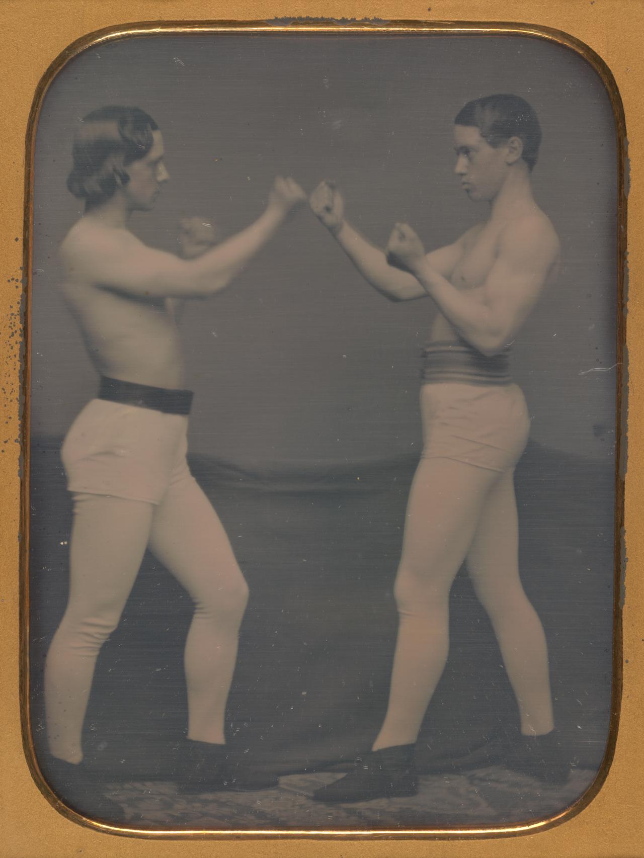 UNKNOWN<br/>
<em>No title (Two boxers)</em> (1850s) <!-- (recto) --><br />

wood, gold, metal, velvet, cardboard, daguerreotype, handcolouring<br />
(12.0 x 8.8 cm) irreg. (image) 15.2 x 12.2 x 1.6 cm (case)<br />
National Gallery of Victoria, Melbourne<br />
Presented by the National Gallery Women's Association, 1995<br />
1995.567<br />

<!--57103-->